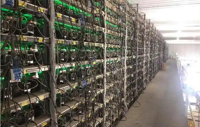 A miner carefully inspecting the hardware of a mining rig, ensuring optimal performance.