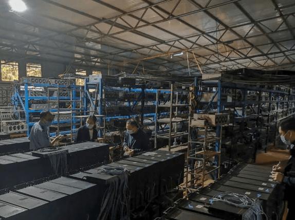 A large cryptocurrency mining farm bustling with mining rigs and cooling infrastructure